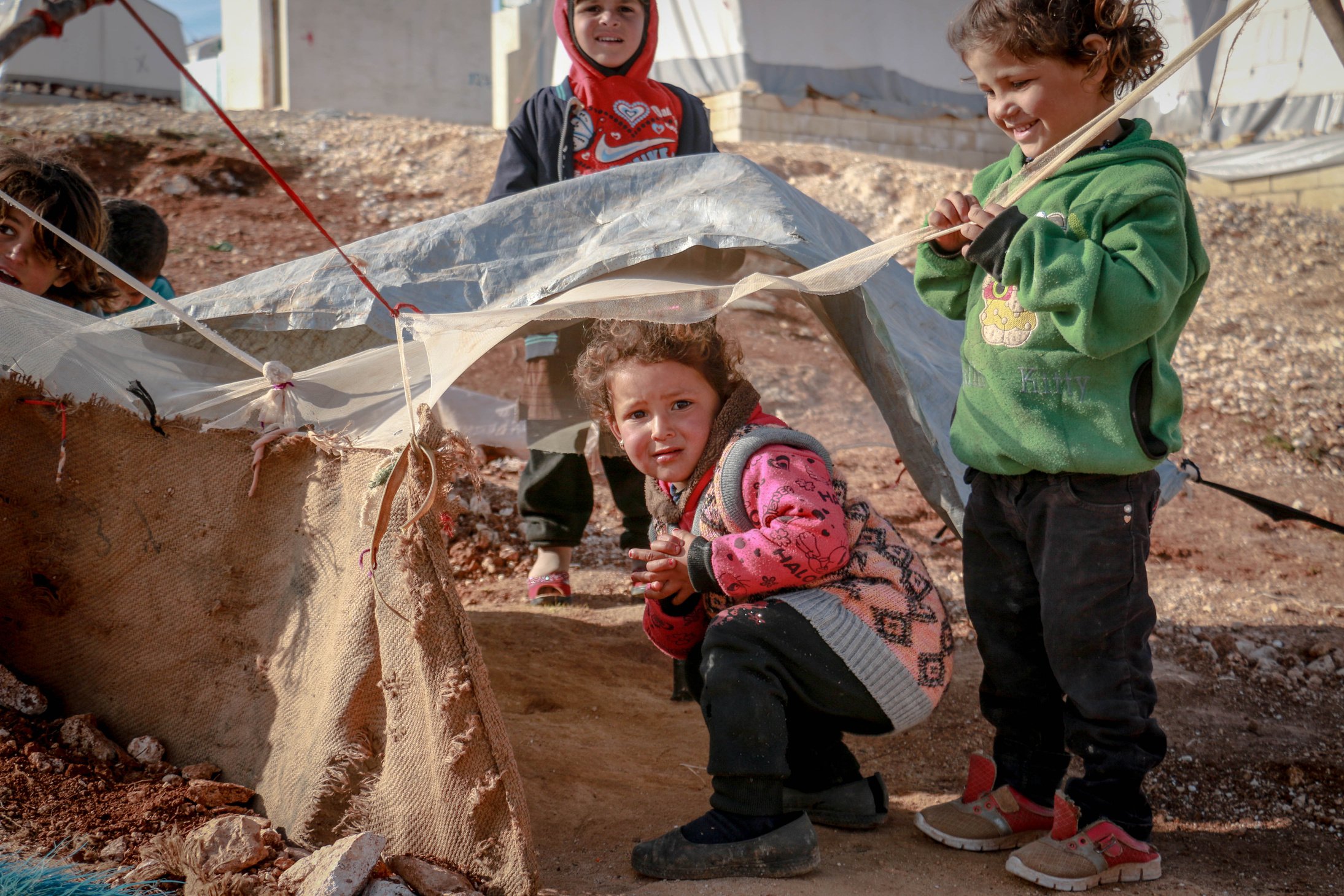 Poor ethnic children playing in yard of village